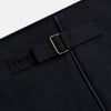 View 9 of product The Casino Royale Midnight Blue Tuxedo Trousers in Wool by Turnbull & Asser UK are shown from the back, expertly crafted from virgin wool in a signature tuxedo style, featuring two buttoned back pockets and adjustable side tabs at the waistband.