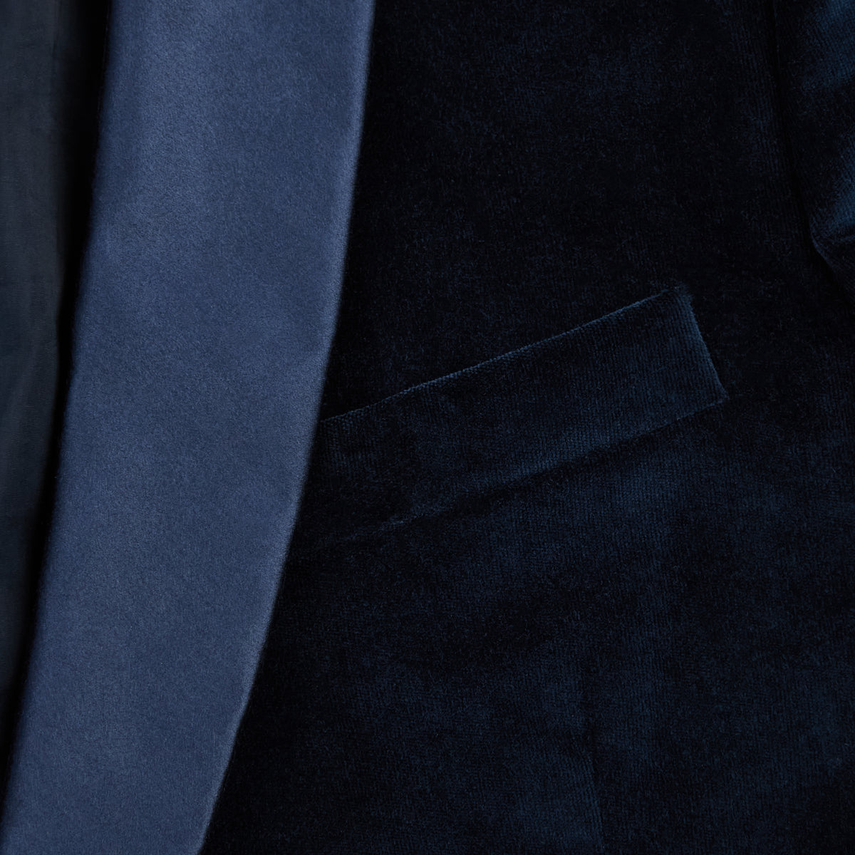 View 6 of product Turnbull & Asser UK’s Casino Royale Midnight Blue Tuxedo Jacket in Cotton Velvet, featuring a single button closure and a luxurious silk-satin shawl lapel, is showcased against a plain white background.