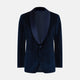 Turnbull & Asser UK’s Casino Royale Midnight Blue Tuxedo Jacket in Cotton Velvet, featuring a single button closure and a luxurious silk-satin shawl lapel, is showcased against a plain white background.