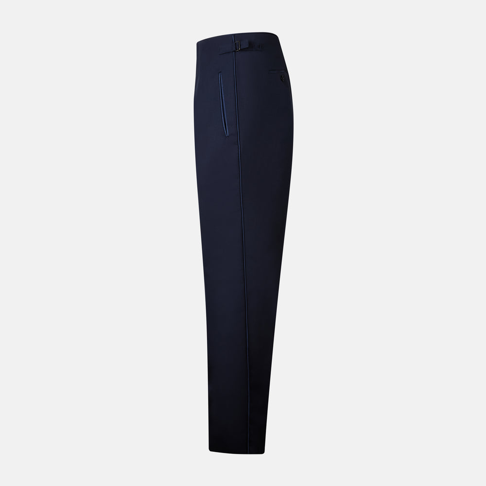 The Casino Royale Midnight Blue Tuxedo Trousers in Wool by Turnbull & Asser UK are shown from the back, expertly crafted from virgin wool in a signature tuxedo style, featuring two buttoned back pockets and adjustable side tabs at the waistband.