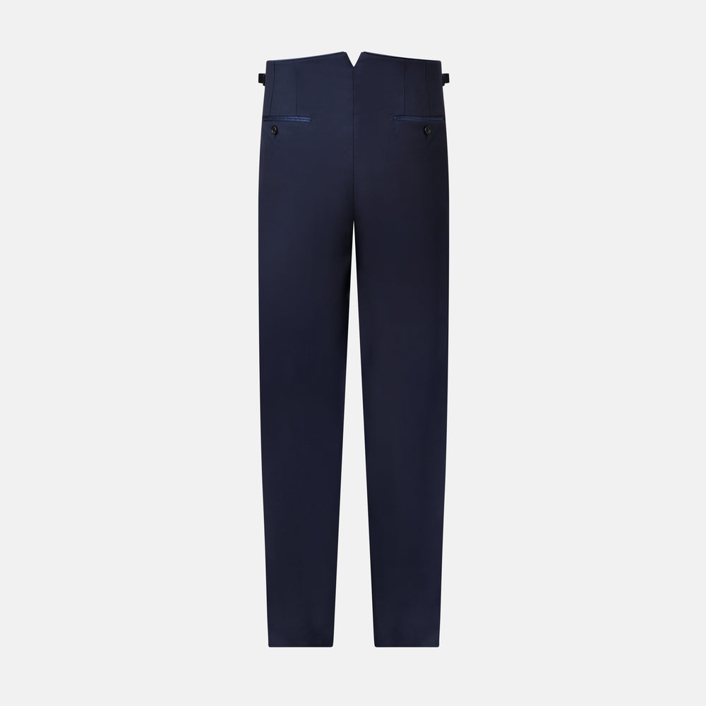 The Casino Royale Midnight Blue Tuxedo Trousers in Wool by Turnbull & Asser UK are shown from the back, expertly crafted from virgin wool in a signature tuxedo style, featuring two buttoned back pockets and adjustable side tabs at the waistband.