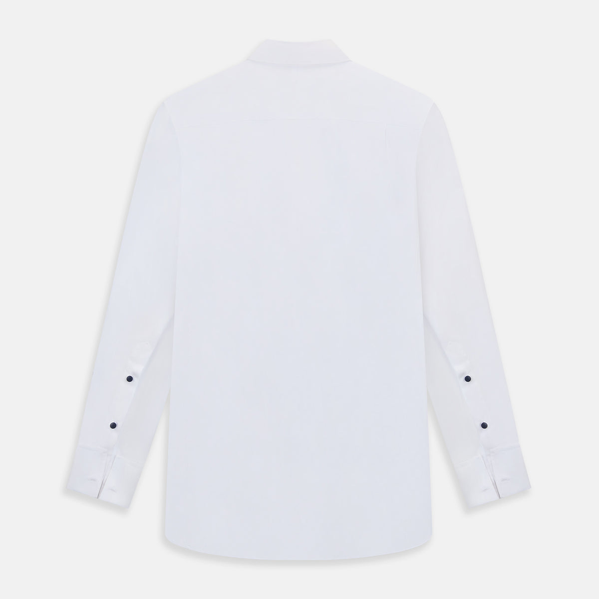 View 9 of product The Casino Royale White Dress Shirt in Cotton by Turnbull & Asser UK is a long-sleeve white dress shirt, crafted from crisp white cotton poplin with a pleated bib front, black buttons, and a classic collar, shown laid flat on a white background.
