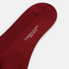 View 3 of product A single Burgundy Mid-Length Merino Sock by Turnbull & Asser, ribbed and crafted from soft merino wool, is displayed upright against a plain white background.