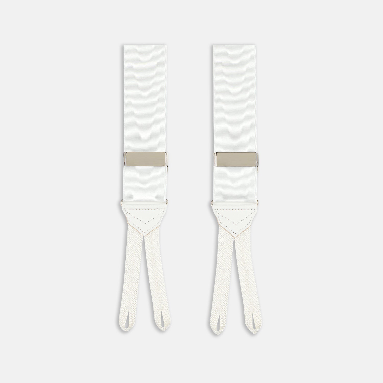 View 1 of product Two White Casino Royale Braces by Turnbull & Asser, as seen on James Bond, handmade in England with silver metal adjusters and leather detailing at the ends—displayed against a plain white background and offering the perfect finishing touch for a 007-inspired look.