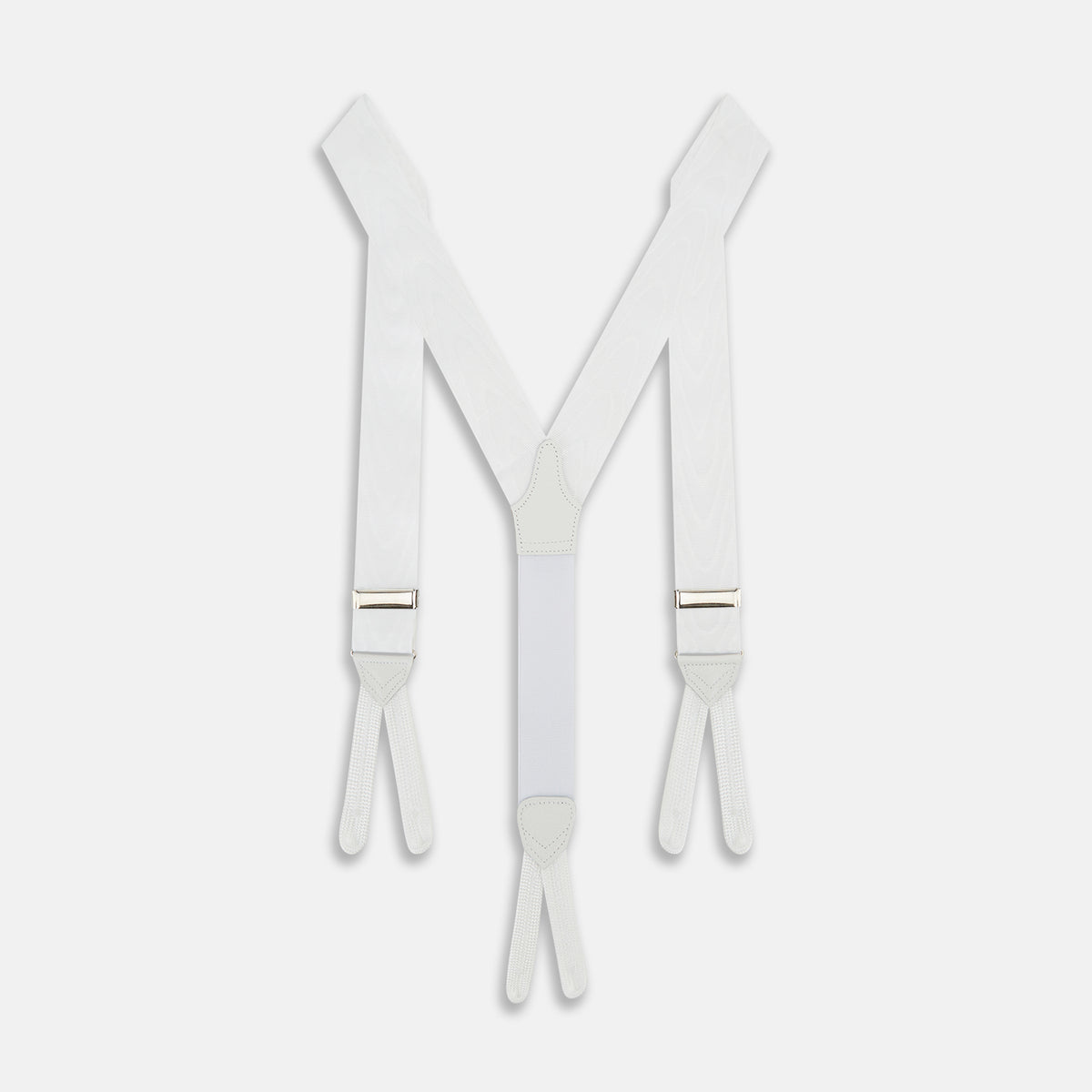 View 1 of product A pair of Casino Royale White Braces by Turnbull & Asser, as seen on James Bond, featuring elegant white moiré fabric with elastic suspender straps, metal adjusters, and leather ends—displayed on a plain white background.