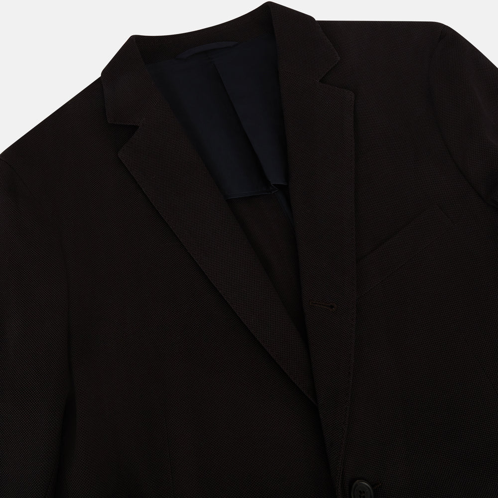 The Turnbull & Asser Dark Chocolate Knitted London Blazer features a notched lapel, two buttons, and two front pockets for versatile everyday wear. Shown against a plain white background.