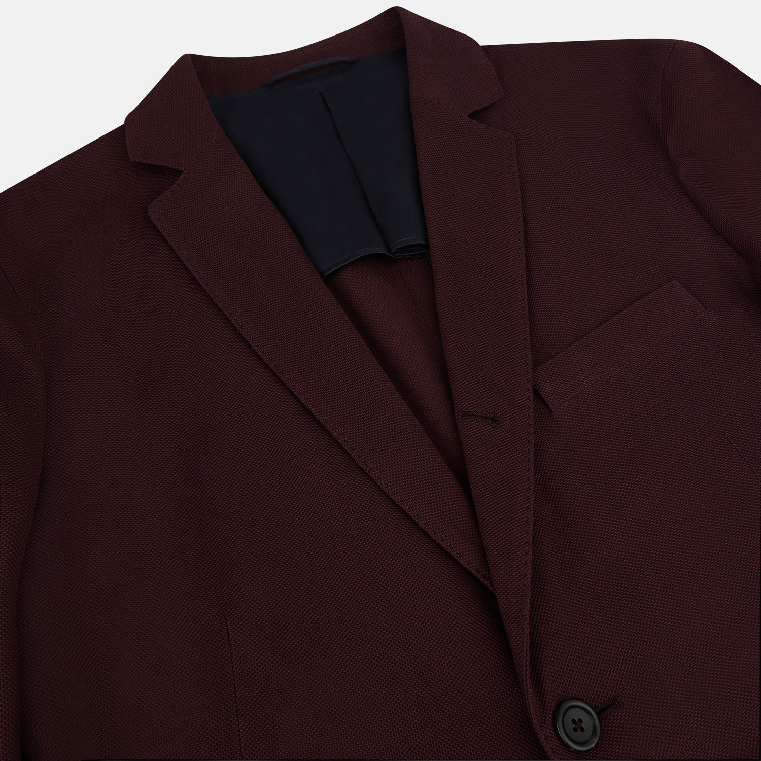 View 2 of product The Turnbull & Asser Burgundy Knitted London Blazer features notch lapels, two front buttons, flap pockets, and a welt chest pocket—ideal for spring and summer—shown against a plain white background.