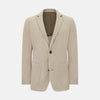 View 1 of product The Turnbull & Asser UK Sand Silk & Cotton Bath Blazer showcases Italian craftsmanship with notched lapels, two front buttons, large patch pockets, and a chest pocket, all set against a plain white background.
