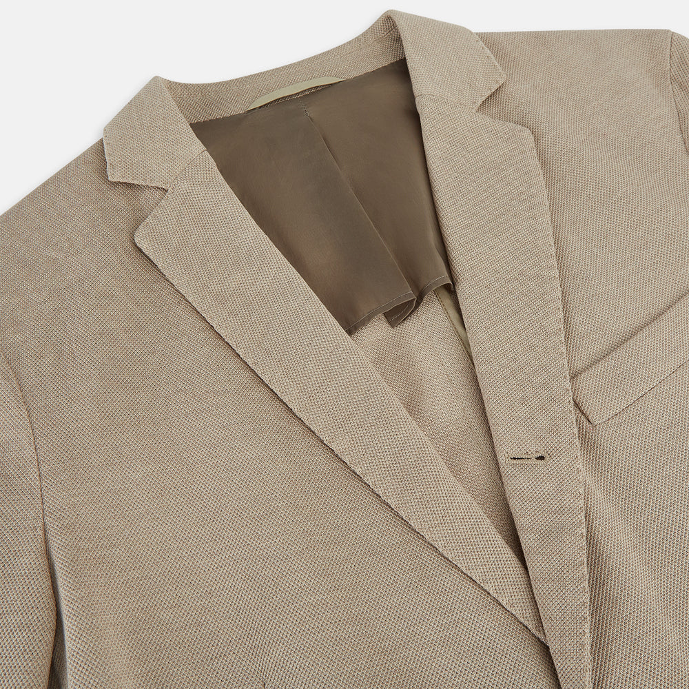The Turnbull & Asser UK Sand Silk & Cotton Bath Blazer showcases Italian craftsmanship with notched lapels, two front buttons, large patch pockets, and a chest pocket, all set against a plain white background.