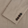 View 4 of product The Turnbull & Asser UK Sand Silk & Cotton Bath Blazer showcases Italian craftsmanship with notched lapels, two front buttons, large patch pockets, and a chest pocket, all set against a plain white background.