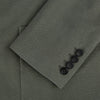 View 4 of product The Turnbull & Asser UK Sage Silk & Cotton Bath Blazer is a single-breasted Italian-tailored piece in olive green, featuring notch lapels, two front patch pockets, a chest pocket, and two buttons, shown on a plain white background.