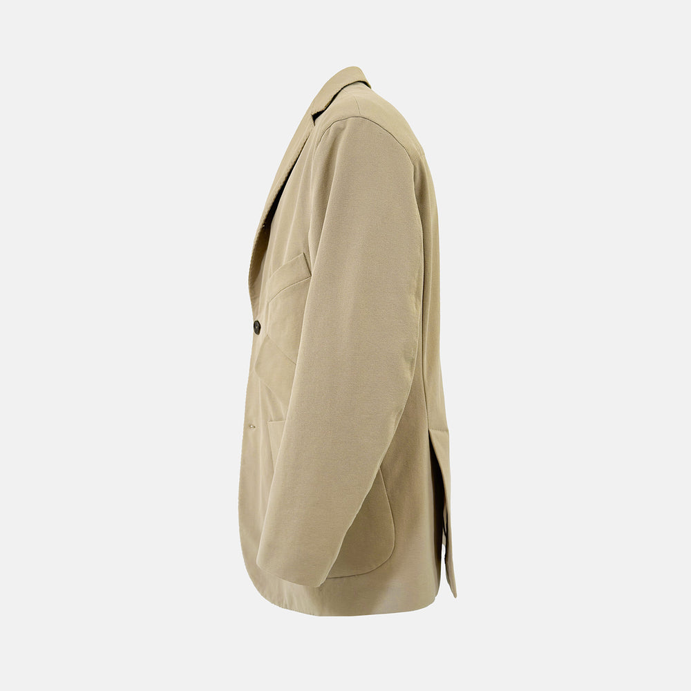 Riviera Sand Oversized Blazer in Cotton by Turnbull & Asser UK, featuring two spacious front pockets, a single chest pocket, and a classic notched lapel. Expertly tailored from premium cotton-nylon stretch fabric, this blazer is shown front-facing against a clean white background—an essential piece for achieving effortless sophistication.