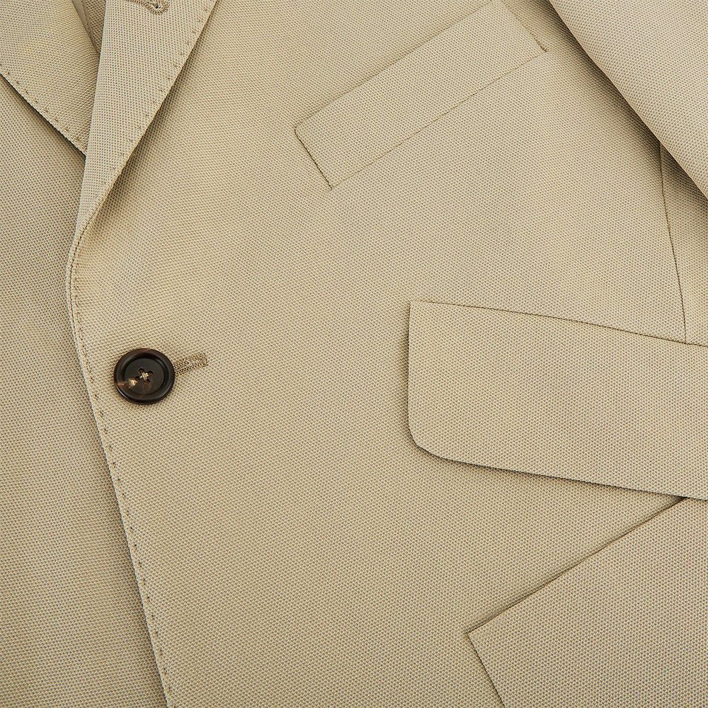 Riviera Sand Oversized Blazer in Cotton by Turnbull & Asser UK, featuring two spacious front pockets, a single chest pocket, and a classic notched lapel. Expertly tailored from premium cotton-nylon stretch fabric, this blazer is shown front-facing against a clean white background—an essential piece for achieving effortless sophistication.