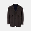 View 1 of product Introducing the Riviera Chocolate Oversized Blazer in Cotton by Turnbull & Asser UK—a dark brown blazer featuring two front buttons, three patch pockets, and notch lapels. Crafted from a cotton-nylon stretch fabric and showcased against a plain white background, this piece is a timeless addition to your autumn wardrobe.