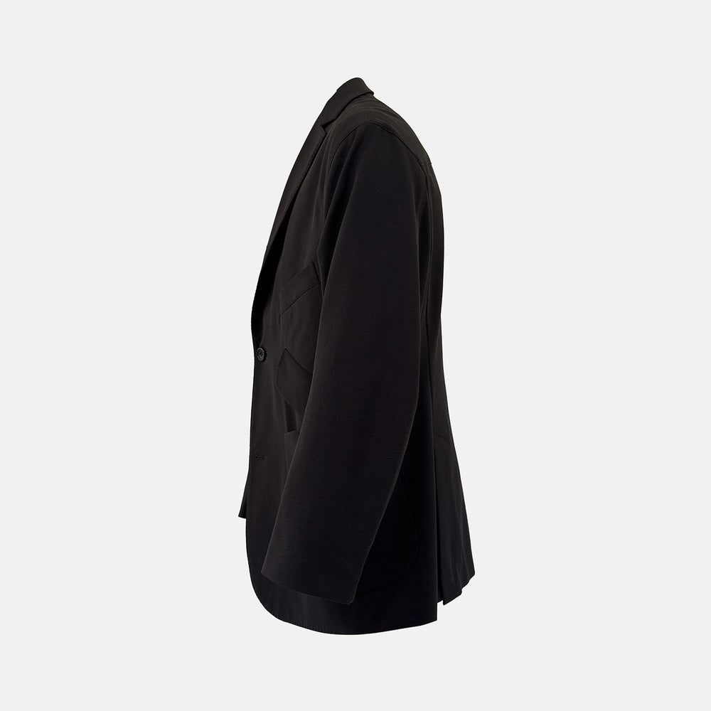 Introducing the Riviera Chocolate Oversized Blazer in Cotton by Turnbull & Asser UK—a dark brown blazer featuring two front buttons, three patch pockets, and notch lapels. Crafted from a cotton-nylon stretch fabric and showcased against a plain white background, this piece is a timeless addition to your autumn wardrobe.