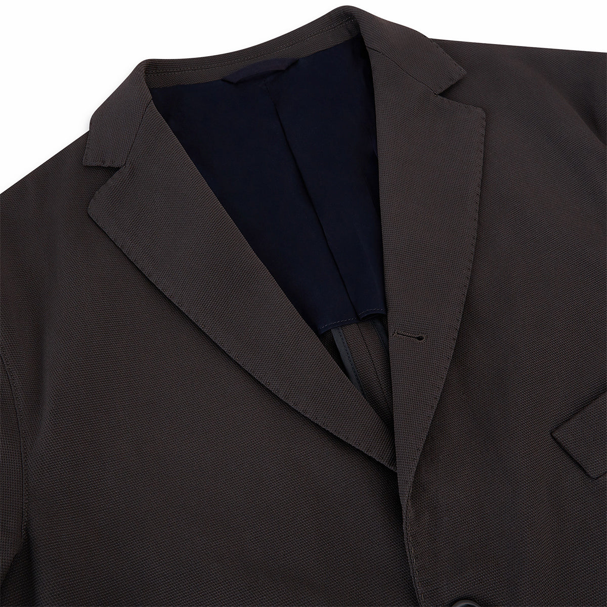 View 7 of product Introducing the Riviera Chocolate Oversized Blazer in Cotton by Turnbull & Asser UK—a dark brown blazer featuring two front buttons, three patch pockets, and notch lapels. Crafted from a cotton-nylon stretch fabric and showcased against a plain white background, this piece is a timeless addition to your autumn wardrobe.