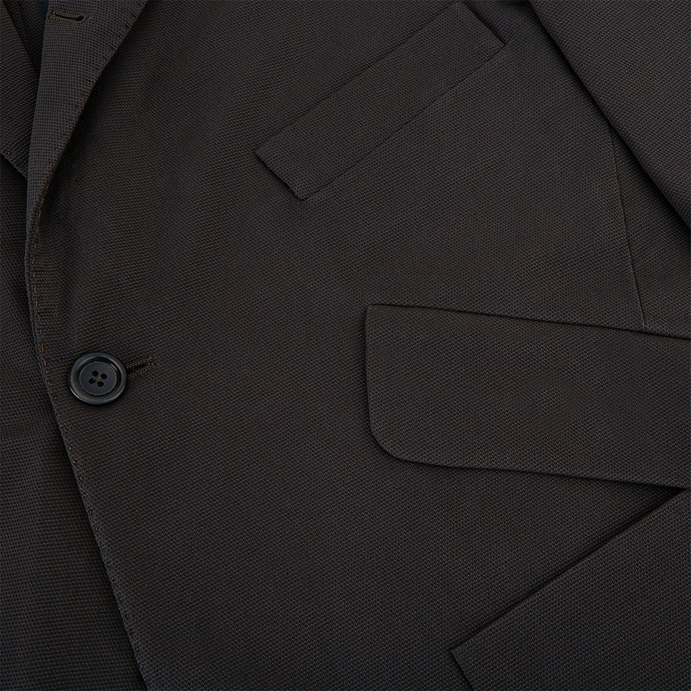Introducing the Riviera Chocolate Oversized Blazer in Cotton by Turnbull & Asser UK—a dark brown blazer featuring two front buttons, three patch pockets, and notch lapels. Crafted from a cotton-nylon stretch fabric and showcased against a plain white background, this piece is a timeless addition to your autumn wardrobe.