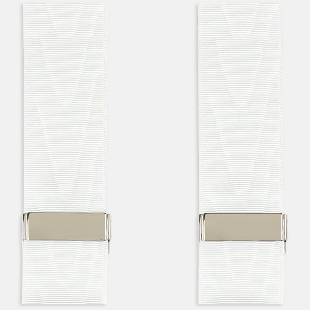 A pair of Casino Royale White Braces by Turnbull & Asser, as seen on James Bond, featuring elegant white moiré fabric with elastic suspender straps, metal adjusters, and leather ends—displayed on a plain white background.
