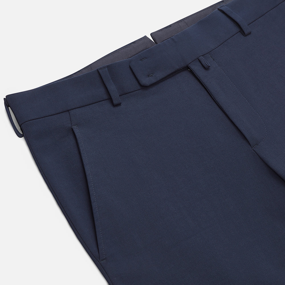The Navy Blue James Trouser by Turnbull & Asser features a tailored straight-leg cut, flat front, belt loops, and button closure, shown on a plain white background for an elegant and versatile look.