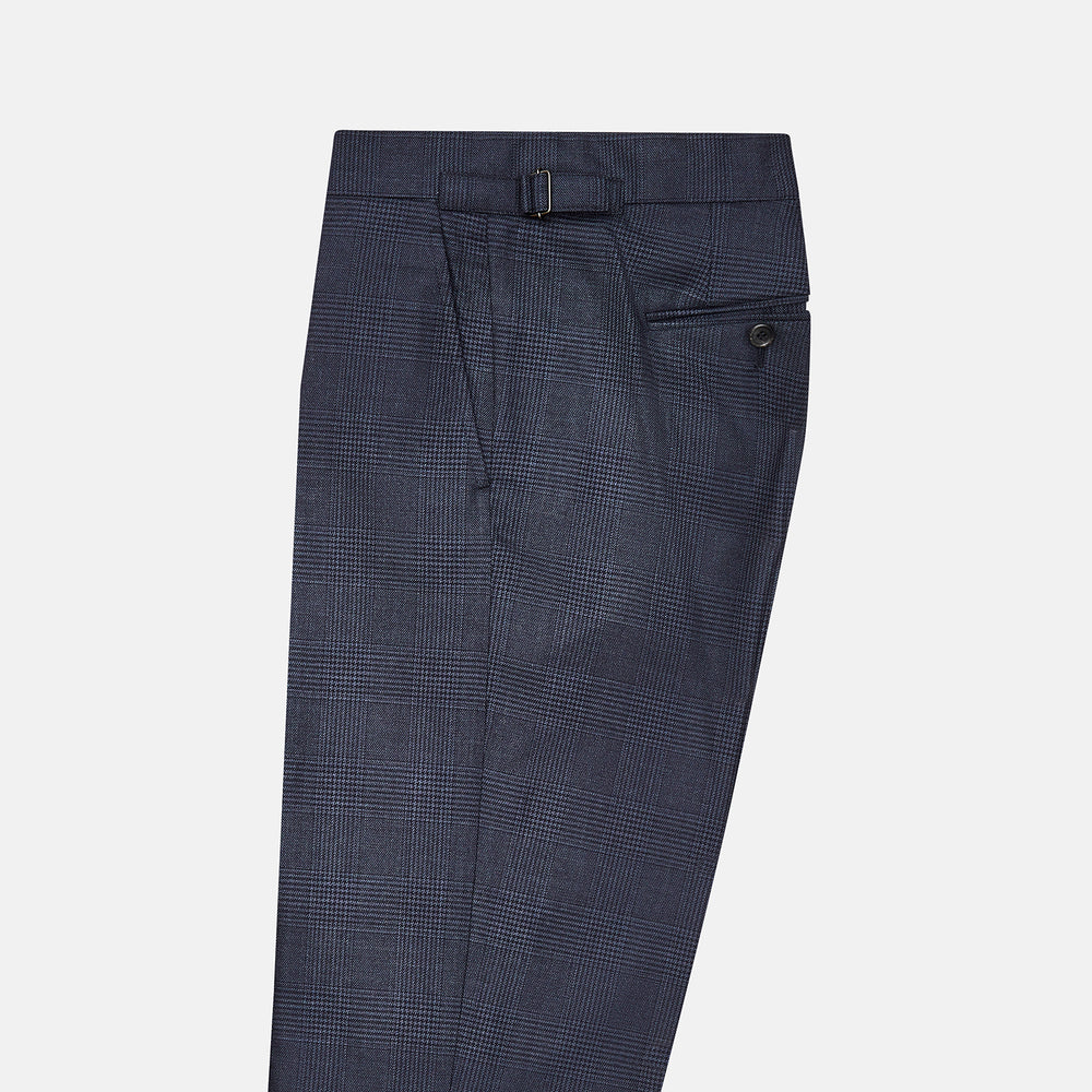 The Navy Check Henry Trousers by Turnbull & Asser are tailored-fit, dark blue pants with a subtle check pattern, front pockets, button closure, and belt loops, crafted from premium Italian wool and displayed on a plain white background.