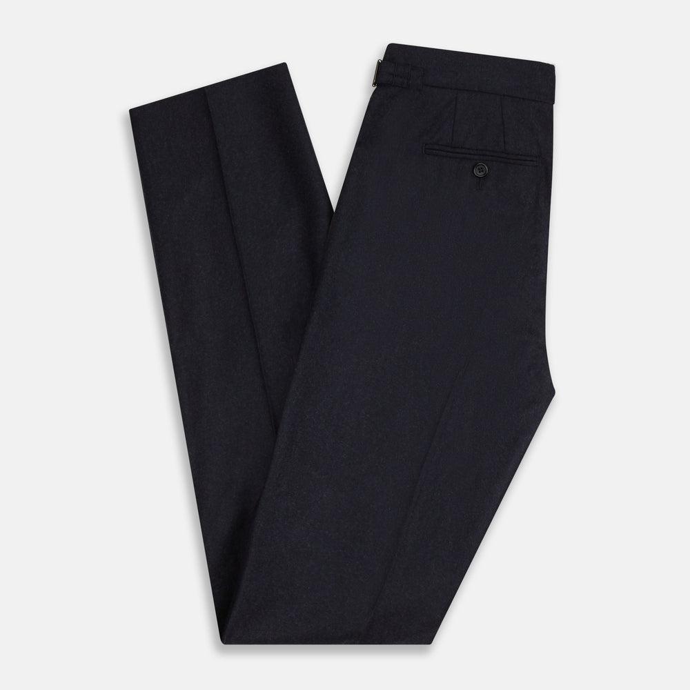 The Turnbull & Asser Navy Henry Trousers are tailored from a luxurious wool-cashmere blend, featuring front pleats, straight legs, and a button closure. Shown here laid flat on a white background.