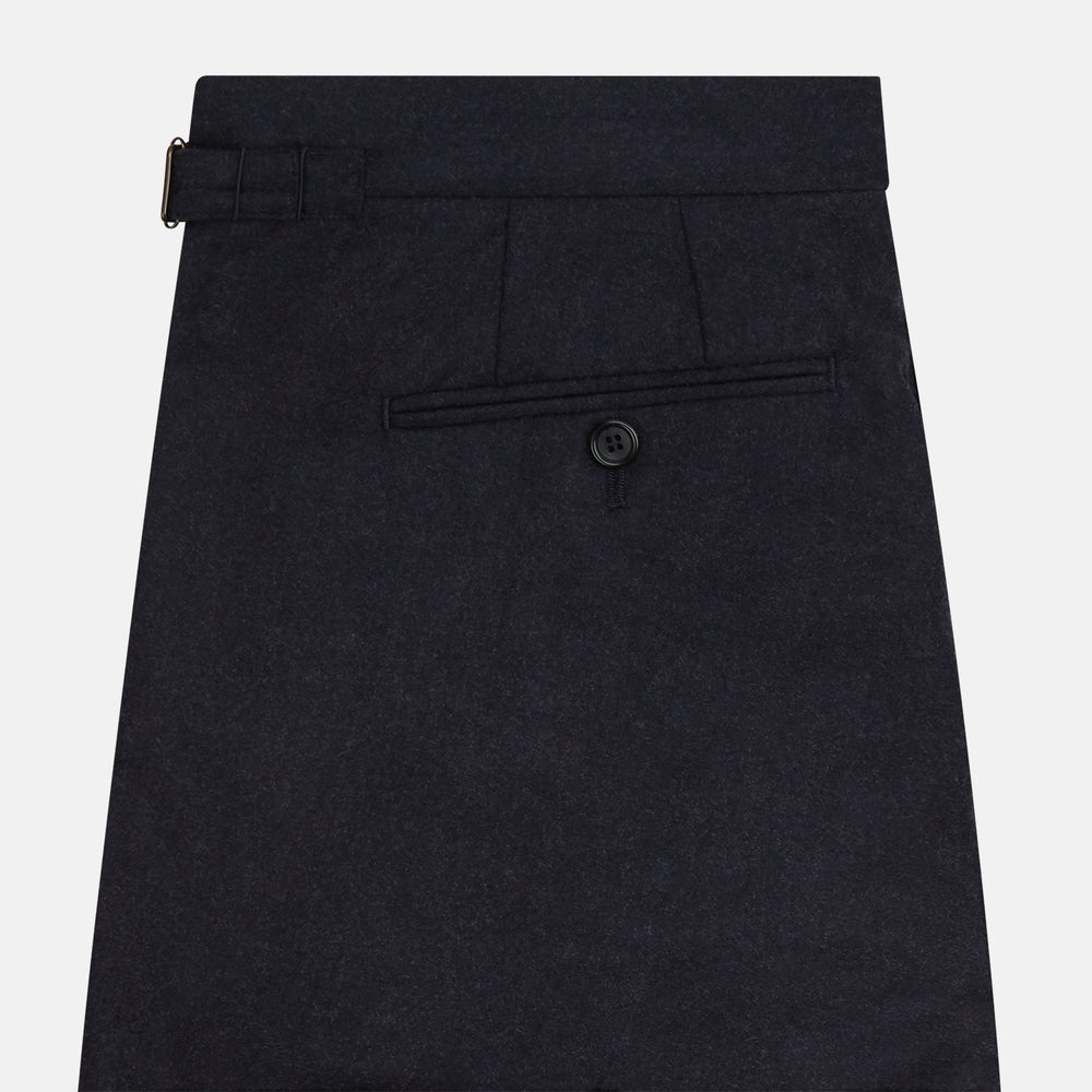 The Turnbull & Asser Navy Henry Trousers are tailored from a luxurious wool-cashmere blend, featuring front pleats, straight legs, and a button closure. Shown here laid flat on a white background.