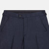 View 2 of product Turnbull & Asser’s Dark Blue Henry Trousers in a wool-cashmere blend feature a button closure, front pleats, and side pockets, shown laid flat on a white background.