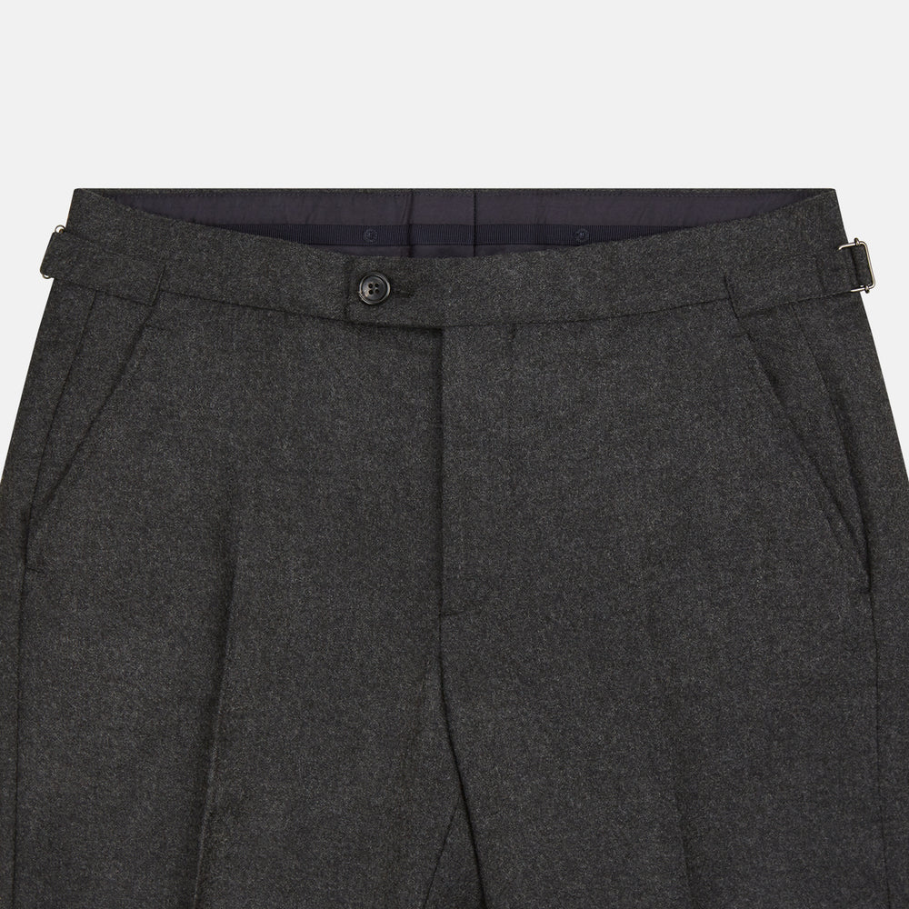Turnbull & Asser's Dark Grey Henry Trousers are tailored, straight-leg trousers in a luxurious wool-cashmere blend with button and zip closure, belt loops, and front pleats, shown against a white background.