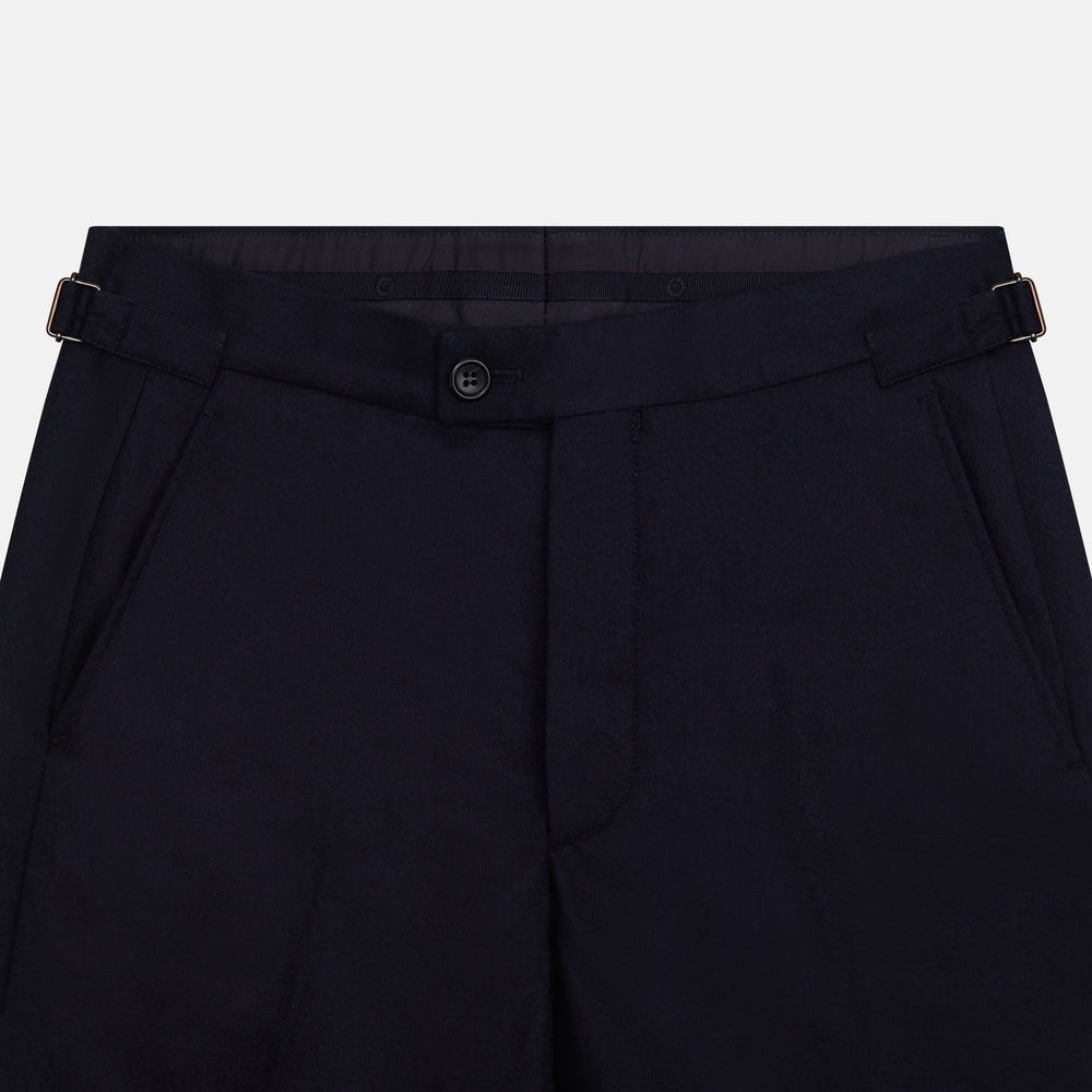 The Turnbull & Asser Midnight Blue Henry Trousers feature a tailored fit, button closure, belt loops, and front pleats in a luxurious wool-cashmere blend, shown against a plain white background.