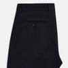 View 5 of product Turnbull & Asser UK Edward Navy Pleated Trousers in Wool Gabardine featuring a button closure, pleated front, and sharp pressed creases.