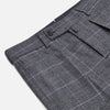 View 2 of product Turnbull & Asser's Grey Check Edward Trousers feature a tailored fit, front pleats, waistband with belt loops, and button closure—crafted from a wool-cotton blend. Ideal for semi-formal wear. Shown on a plain white background.