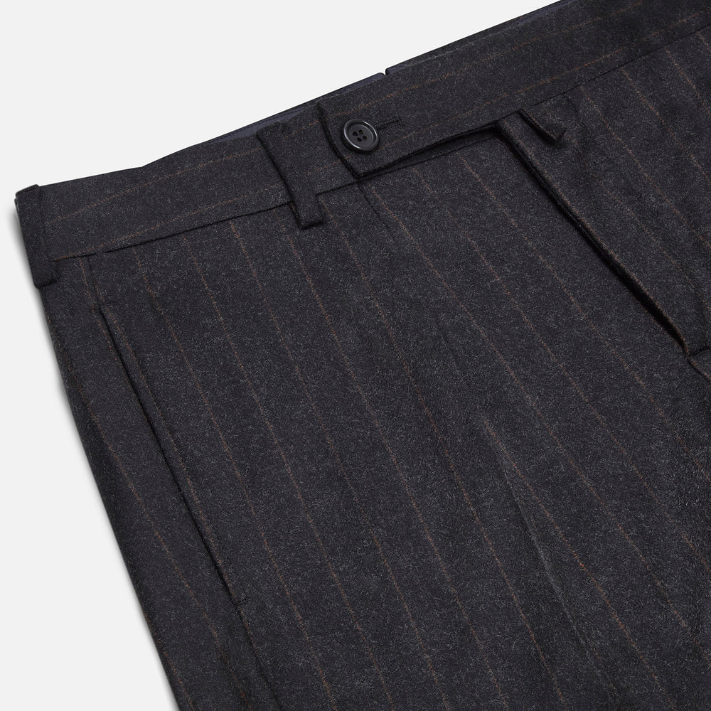 Turnbull & Asser’s Charcoal Pinstripe Edward Trousers, crafted in a wool-cotton blend with subtle vertical pinstripes, feature belt loops, a button closure, and tailored fit, all shown against a plain white background.