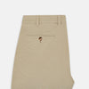 View 4 of product Amberley Sand Trousers in Cotton by Turnbull & Asser UK, featuring a straight-leg silhouette in beige cotton canvas with a button and zip closure, displayed against a plain white background.