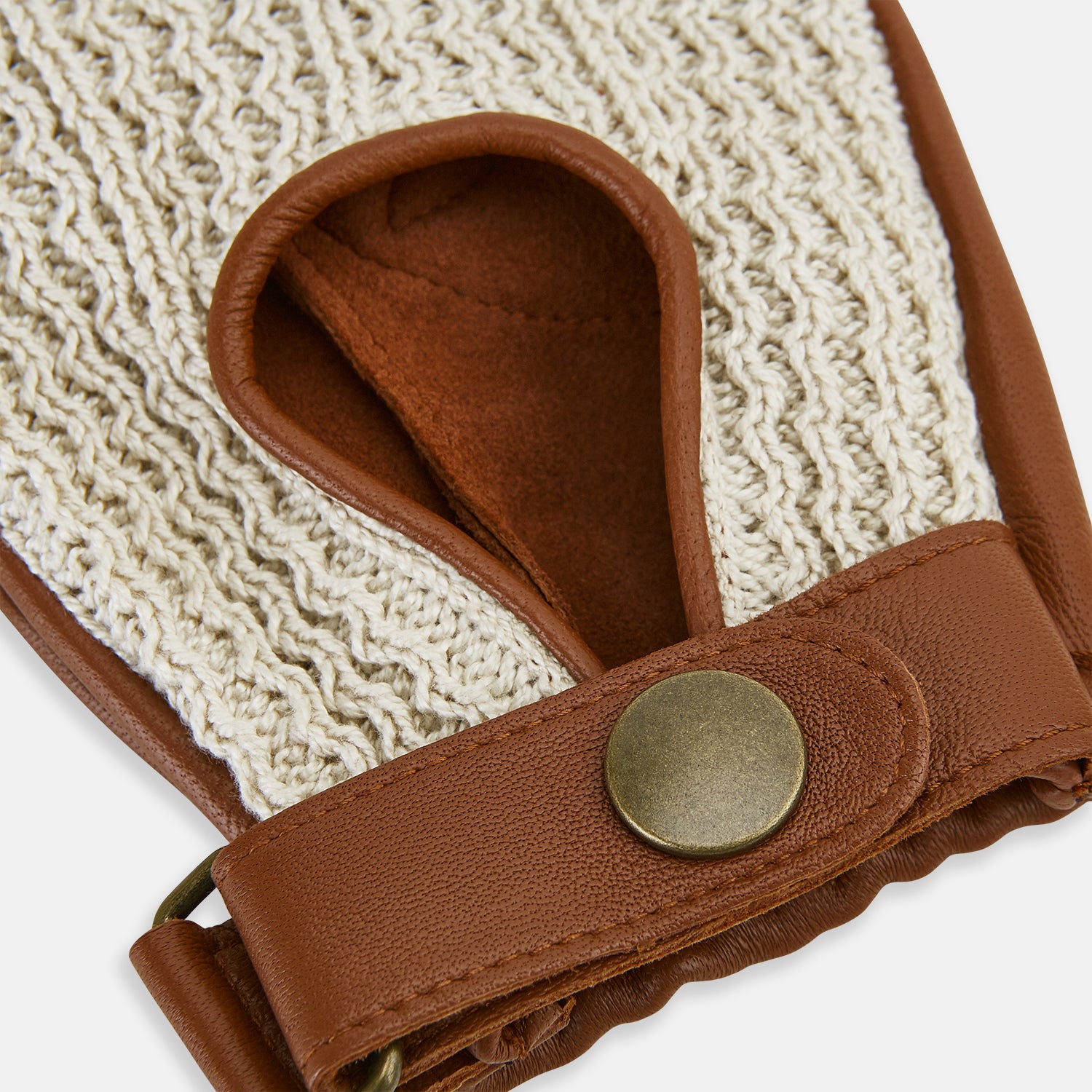 View 3 of product A pair of Cognac Tan Fingerless Driving Gloves in Leather by Turnbull & Asser UK, featuring cream crochet backs, snap closures, and a fingerless design, displayed from the front and back on a white background.