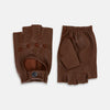 View 1 of product A pair of Turnbull & Asser UK Coffee Brown Fingerless Driving Gloves in leather, featuring perforated knuckles, a snap closure, and an elastic wristband, are displayed palm-up and palm-down on a white background.
