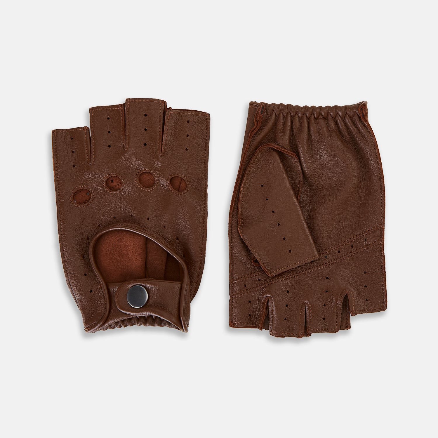 View 1 of product A pair of Turnbull & Asser UK Coffee Brown Fingerless Driving Gloves in leather, featuring perforated knuckles, a snap closure, and an elastic wristband, are displayed palm-up and palm-down on a white background.