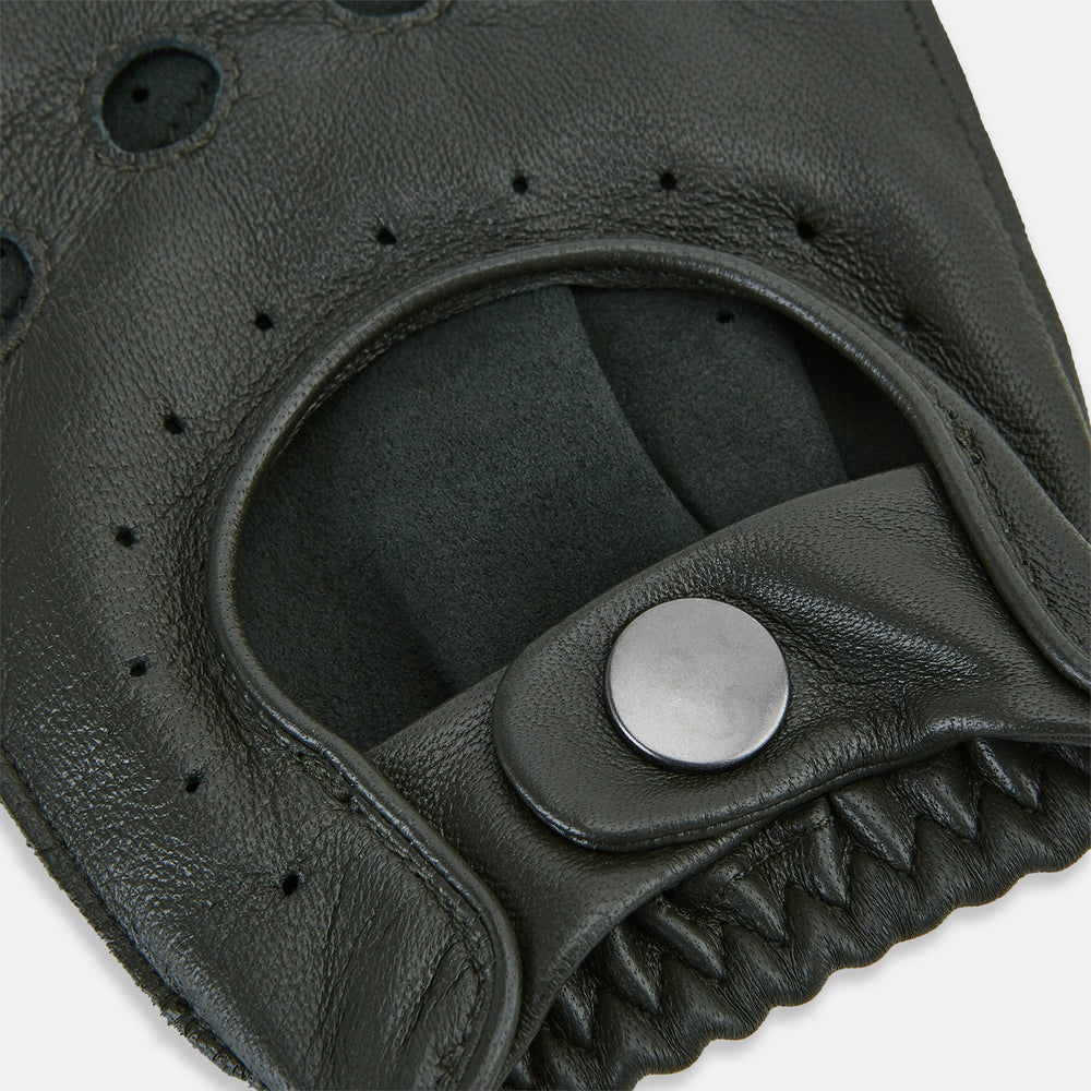 A pair of Forest Green Fingerless Driving Gloves in leather by Turnbull & Asser UK, one displayed palm-up to show the snap closure and the other back-up to highlight the perforated details reminiscent of classic knuckle hole gloves.