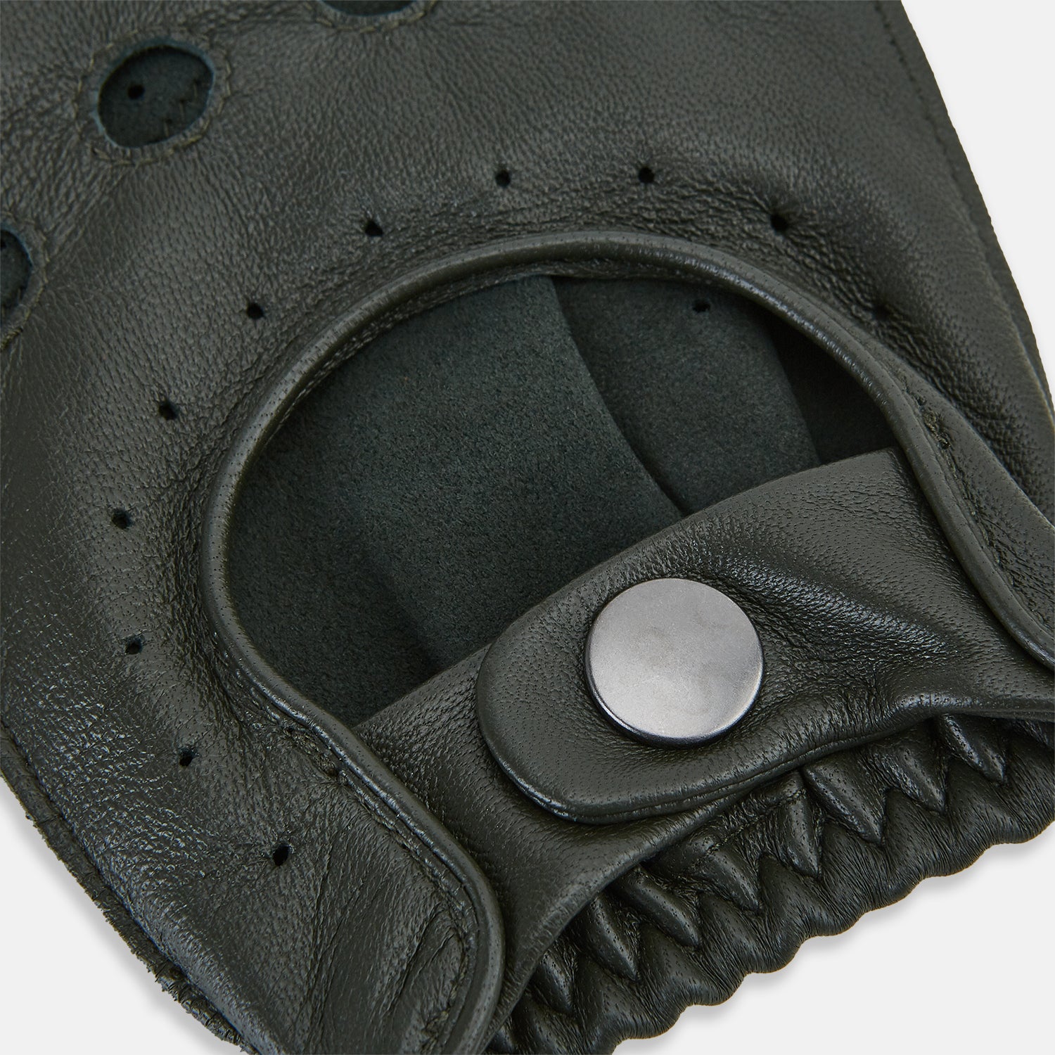View 3 of product A pair of Forest Green Fingerless Driving Gloves in leather by Turnbull & Asser UK, one displayed palm-up to show the snap closure and the other back-up to highlight the perforated details reminiscent of classic knuckle hole gloves.