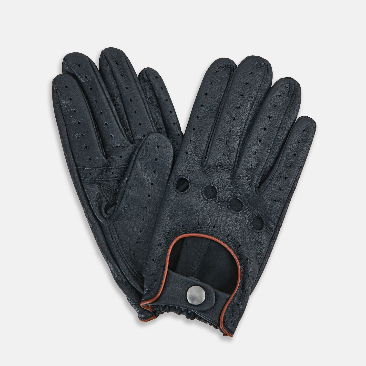 View 2 of product A pair of navy leather driving gloves from Turnbull & Asser UK, featuring perforations and snap closures; one glove displays the palm side while the other shows the back. These unlined Navy Driving Gloves combine style and flexibility for an optimal driving experience.