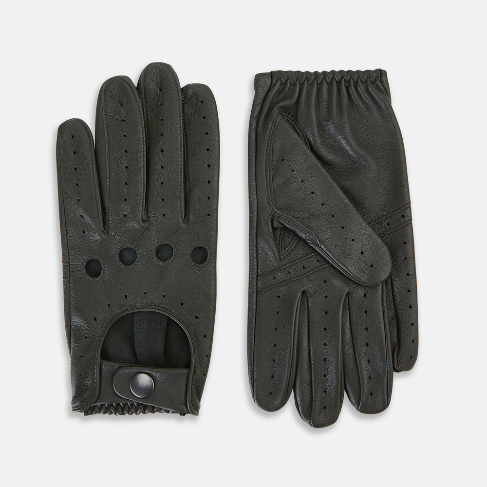 A pair of forest green leather unlined driving gloves from Turnbull & Asser UK, featuring perforated knuckles and backs, snap closures, and visible stitching, displayed flat on a white background. These gloves offer flexibility and comfort for an exceptional driving experience.