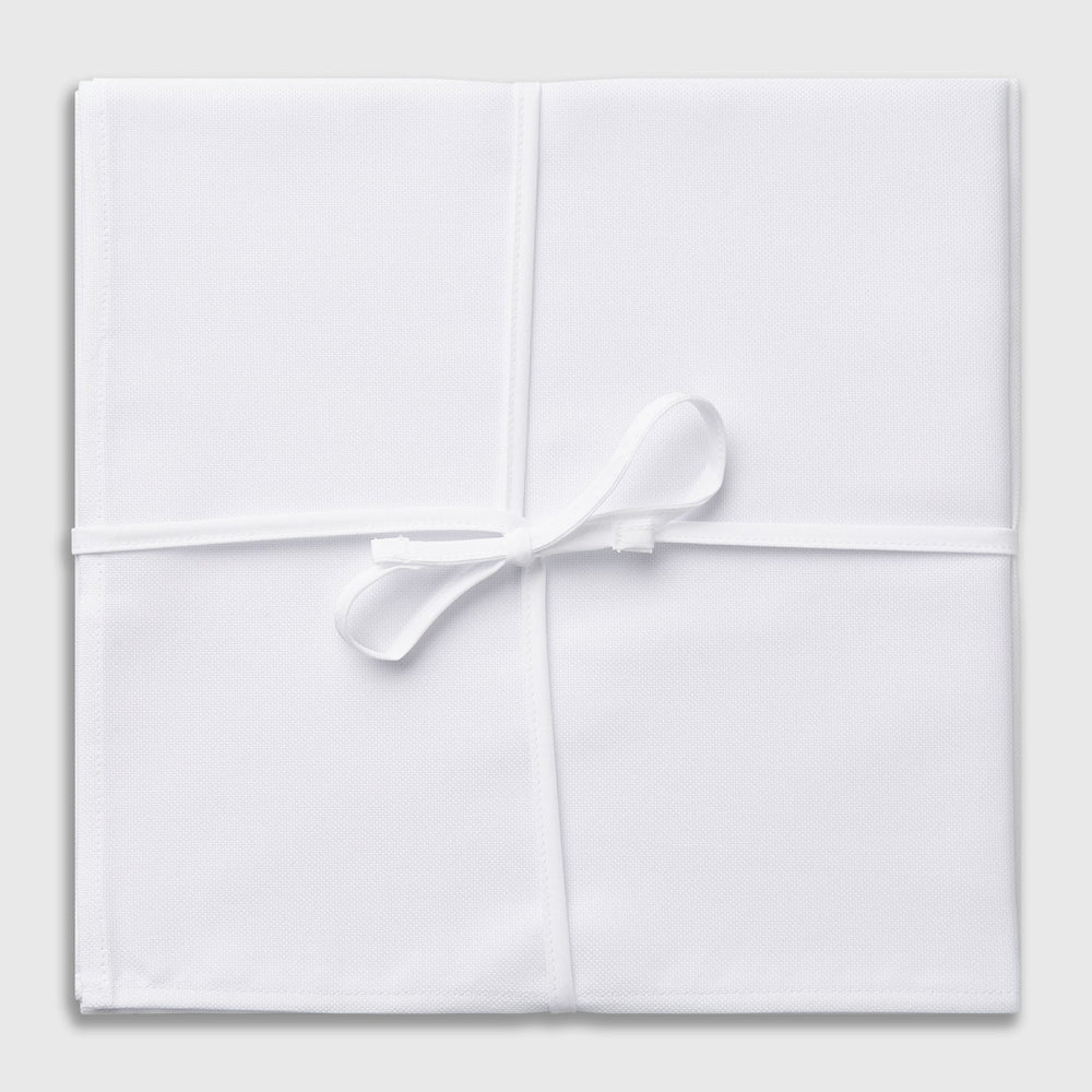 Three Turnbull & Asser Plain White Cotton Handkerchiefs from the 3-pack are neatly folded and overlapping on a light gray background.