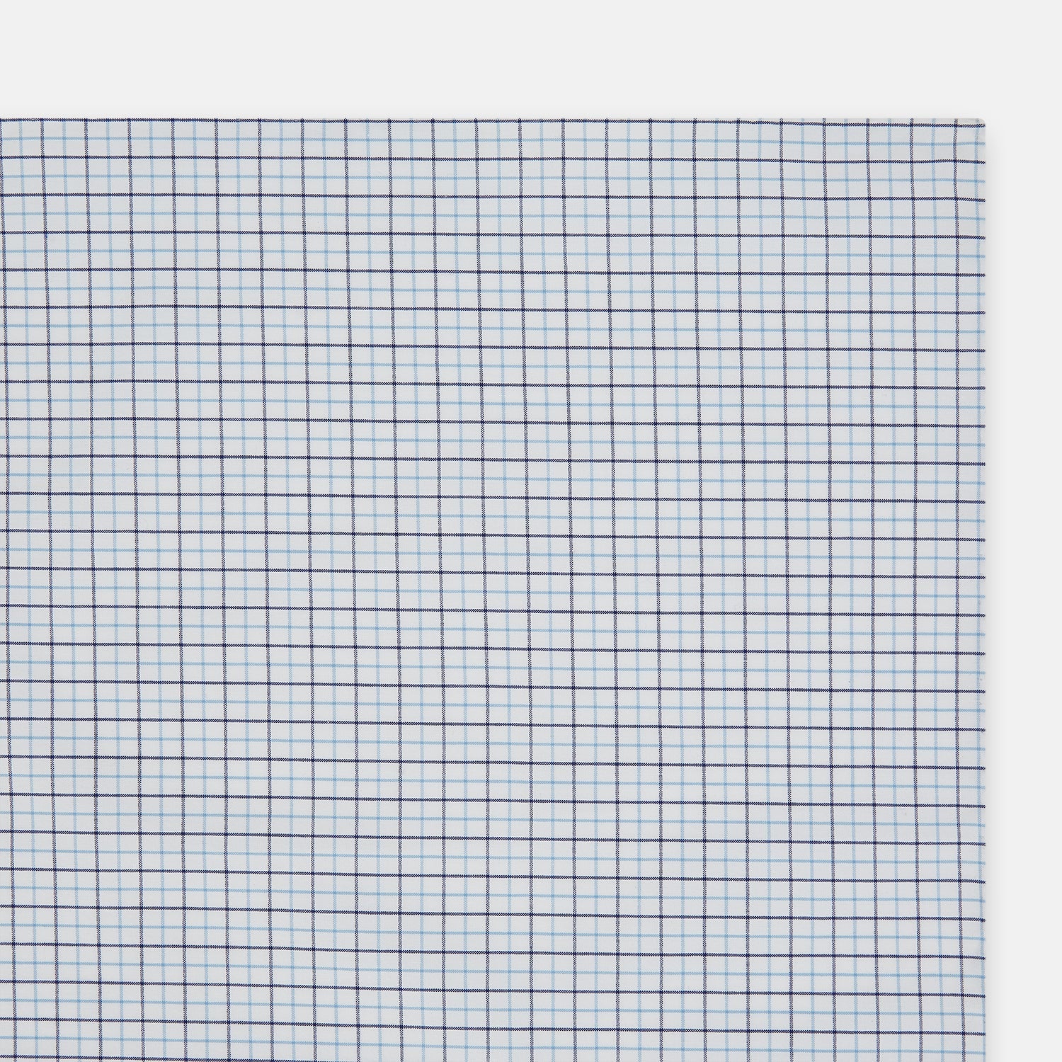 View 2 of product The Turnbull & Asser Hand Rolled Blue Double Graph Check Handkerchief features a cotton square with a blue and navy grid pattern, refined hand-rolled edges, and serves as an elegant gentleman's accessory.