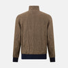 View 3 of product The Fairway Pinecone Golf Jacket in Linen by Turnbull & Asser UK is a brown zip-up jacket featuring a high collar, two side pockets, a zippered chest pocket, and dark cuffs and hem. Crafted from lightweight herringbone linen, it is displayed on a white background.
