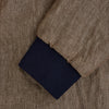 View 4 of product The Fairway Pinecone Golf Jacket in Linen by Turnbull & Asser UK is a brown zip-up jacket featuring a high collar, two side pockets, a zippered chest pocket, and dark cuffs and hem. Crafted from lightweight herringbone linen, it is displayed on a white background.