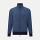 Introducing the Fairway Denim Golf Jacket in Linen by Turnbull & Asser UK—a blue zip-up jacket featuring a high collar, two side pockets, and a zippered chest pocket. The contrasting darker cuffs and hem accentuate its denim-like linen texture, making it the perfect versatile golf jacket for cooler days.