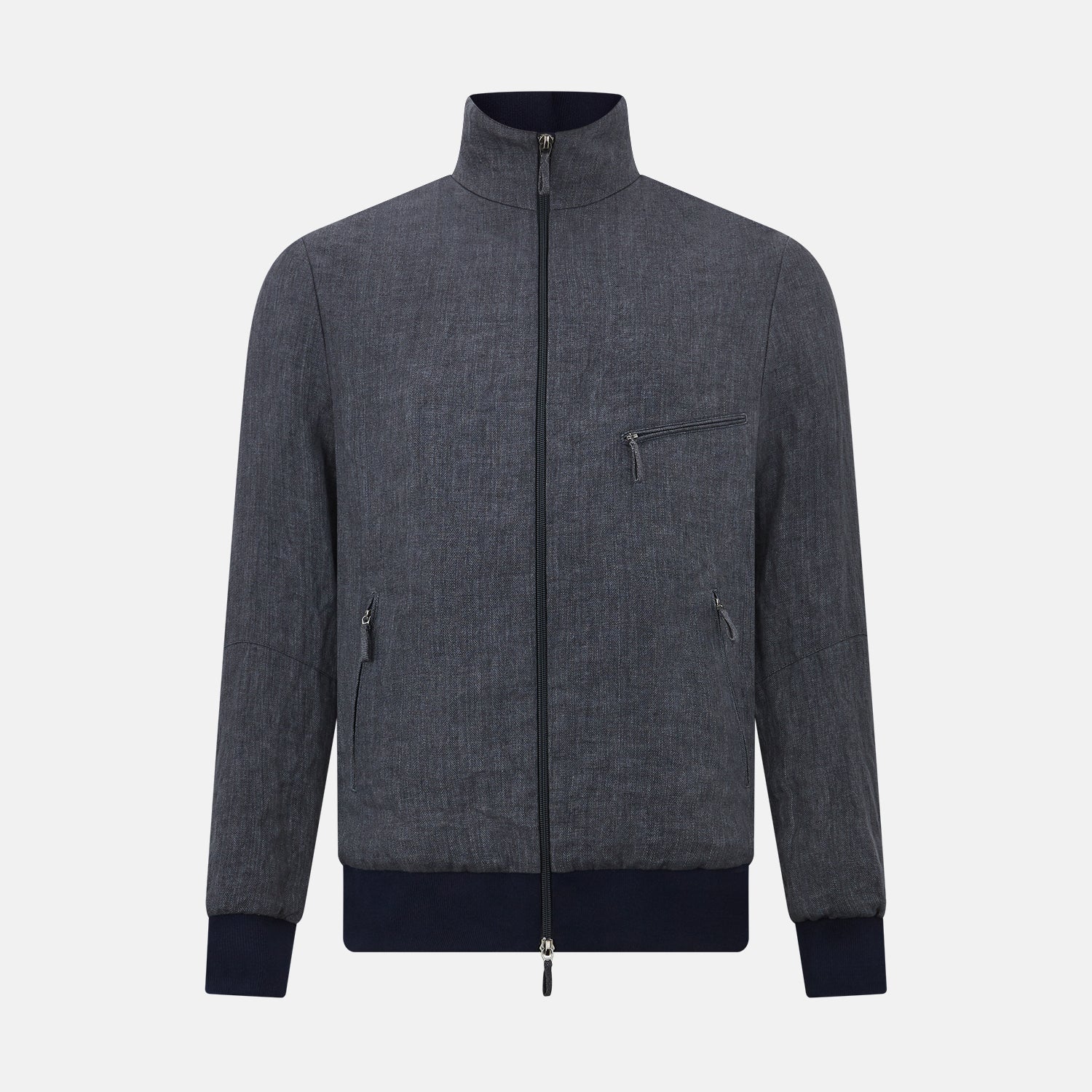 View 1 of product A front view of the Fairway Ash Golf Jacket in Linen by Turnbull & Asser UK is shown, featuring a high collar, two side zip pockets, a chest zip pocket, and black ribbed cuffs and hem. Crafted from lightweight gray herringbone linen for effortless warm-weather dressing, the jacket is displayed on a plain white background.
