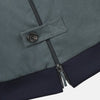 View 2 of product The Fairway Ash Grey Driving Jacket in Cotton by Turnbull & Asser UK features a zip-up design with a raised collar, black ribbed cuffs and hem, and multiple zippered pockets. Photographed on a plain white background, this essential piece from the Driver’s Capsule Collection is an iconic addition to any motoring wardrobe.