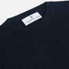 View 2 of product A luxurious navy crew neck cashmere jumper by Turnbull & Asser is laid flat on a white background, evoking timeless Scottish cashmere craftsmanship.