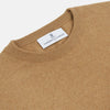 View 2 of product The Turnbull & Asser Camel Crew Neck Merino Wool Jumper is a classic, long-sleeve sweater in camel, laid flat on a white background. Featuring ribbed collar, cuffs, and hem, it’s an essential staple for every gentleman’s wardrobe.
