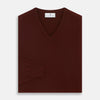 View 3 of product The Turnbull & Asser Port Cashmere V-Neck Jumper is a plain, long-sleeved burgundy sweater with a V-neck, shown flat on a white background.